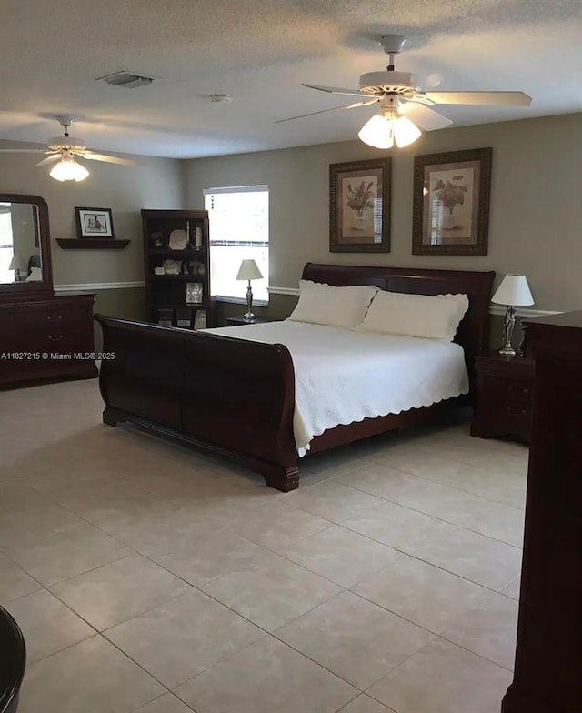 763 S Wind Cir, Sunrise, FL 33326 - bedroom with light tile patterned flooring, a ceiling fan, and a textured ceiling