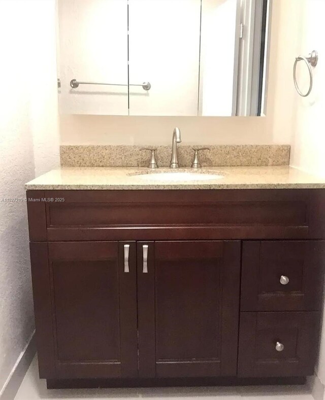 763 S Wind Cir, Sunrise, FL 33326 - bathroom featuring vanity and a textured wall