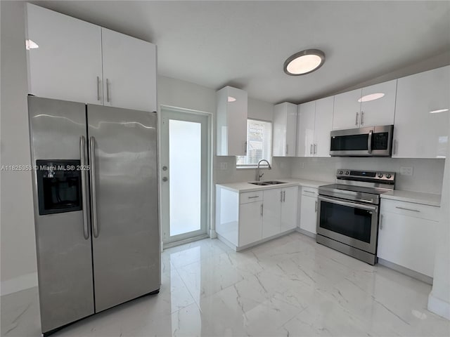 3231 NW 48th Ter, Miami, FL 33142 - kitchen with stainless steel appliances, light marble finish flooring, light countertops, white cabinets, and tasteful backsplash