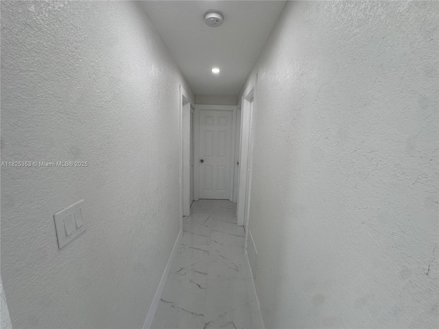3231 NW 48th Ter, Miami, FL 33142 - hall featuring light marble finish flooring and a textured wall