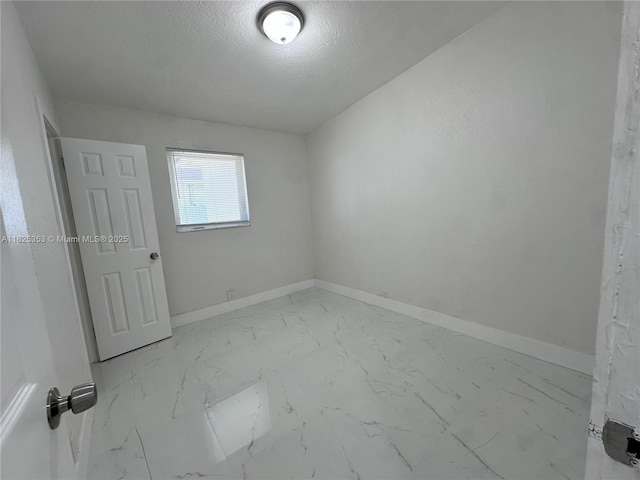 3231 NW 48th Ter, Miami, FL 33142 - spare room featuring marble finish flooring and a textured ceiling