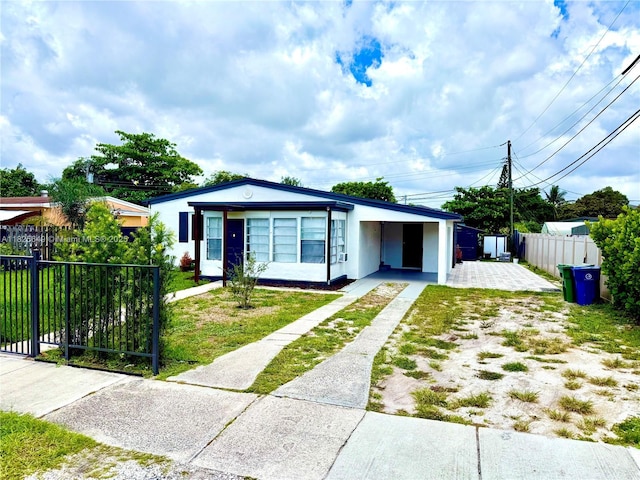 305 SW 24th Ave, Fort Lauderdale, FL 33312 - ranch-style home featuring driveway, an attached carport, and stucco siding