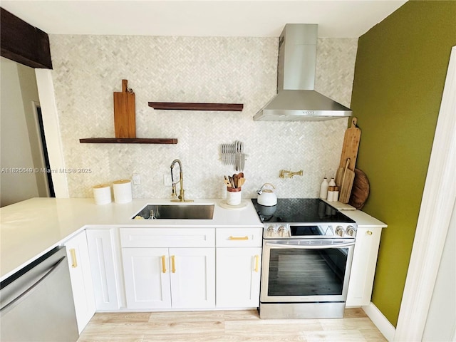 305 SW 24th Ave, Fort Lauderdale, FL 33312 - kitchen with wall chimney exhaust hood, appliances with stainless steel finishes, open shelves, tasteful backsplash, and white cabinetry