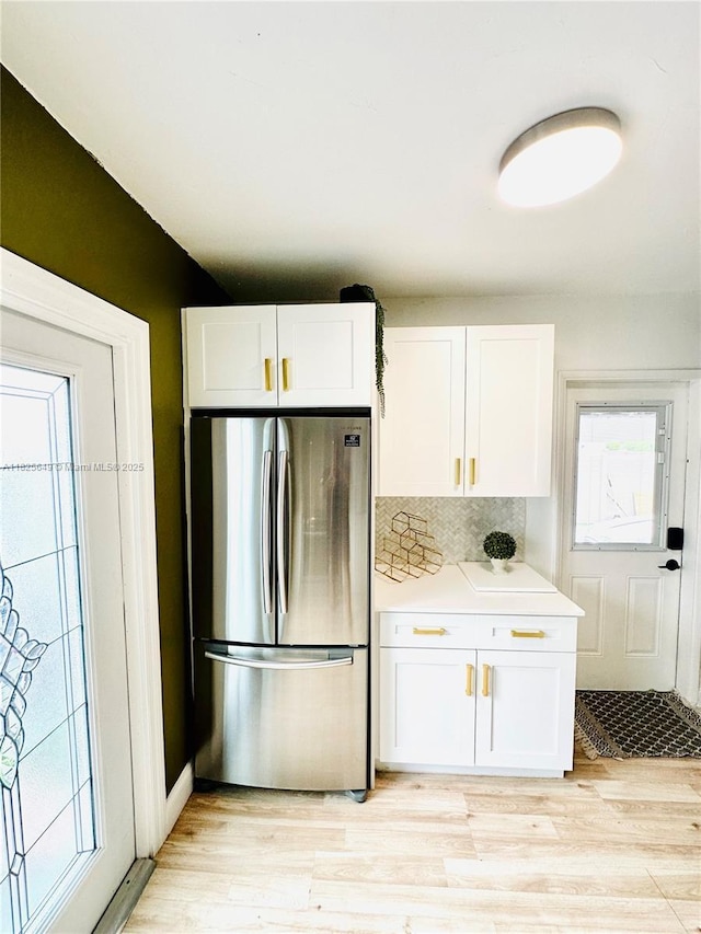 305 SW 24th Ave, Fort Lauderdale, FL 33312 - kitchen featuring freestanding refrigerator, white cabinetry, and light wood-style flooring