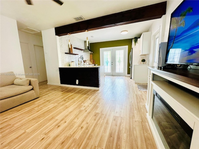 305 SW 24th Ave, Fort Lauderdale, FL 33312 - living room featuring light wood-style flooring, beam ceiling, french doors, and a fireplace