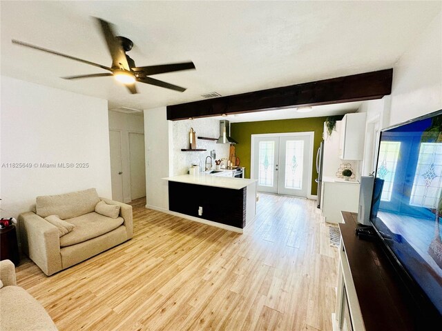 305 SW 24th Ave, Fort Lauderdale, FL 33312 - living area with beamed ceiling, light wood-style flooring, french doors, and a ceiling fan