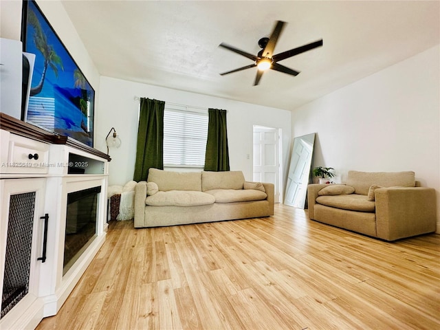 305 SW 24th Ave, Fort Lauderdale, FL 33312 - living room featuring light wood-style flooring, a glass covered fireplace, and ceiling fan