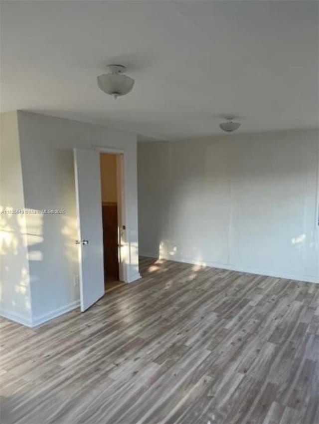 305 SW 24th Ave, Fort Lauderdale, FL 33312 - empty room with wood finished floors and baseboards