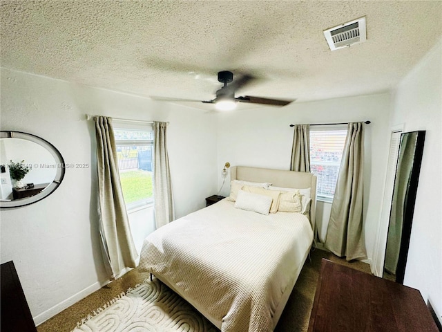 305 SW 24th Ave, Fort Lauderdale, FL 33312 - bedroom featuring multiple windows, carpet floors, ceiling fan, and a textured ceiling