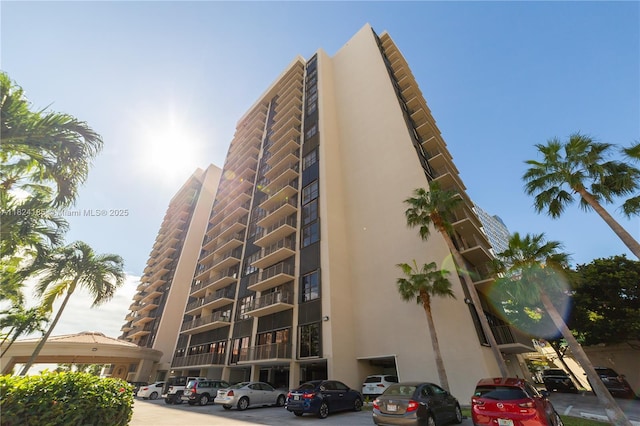 1450 Brickell Bay Dr Unit 311, Miami, FL 33131 - view of building exterior featuring uncovered parking