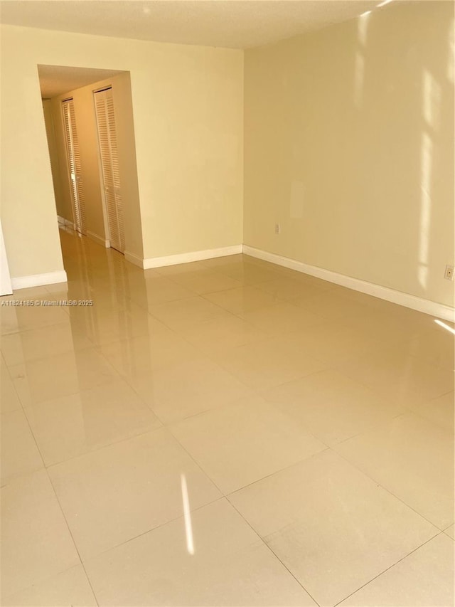 1450 Brickell Bay Dr Unit 311, Miami, FL 33131 - spare room featuring tile patterned floors and baseboards