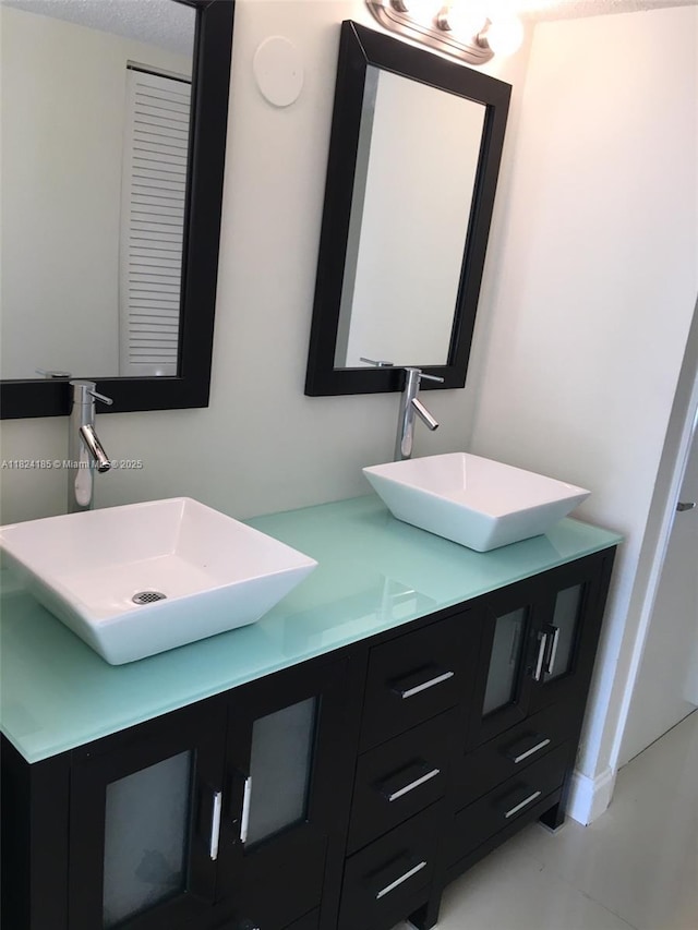1450 Brickell Bay Dr Unit 311, Miami, FL 33131 - bathroom with double vanity and tile patterned flooring