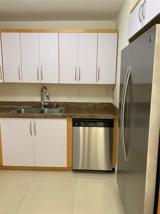 1450 Brickell Bay Dr Unit 311, Miami, FL 33131 - kitchen with appliances with stainless steel finishes, white cabinets, and dark countertops