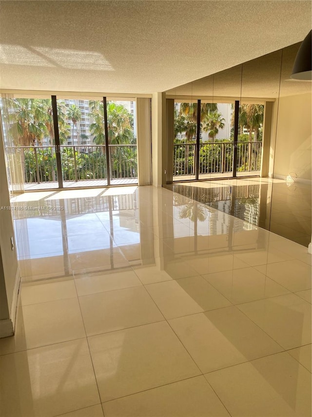 1450 Brickell Bay Dr Unit 311, Miami, FL 33131 - spare room with tile patterned flooring and a textured ceiling