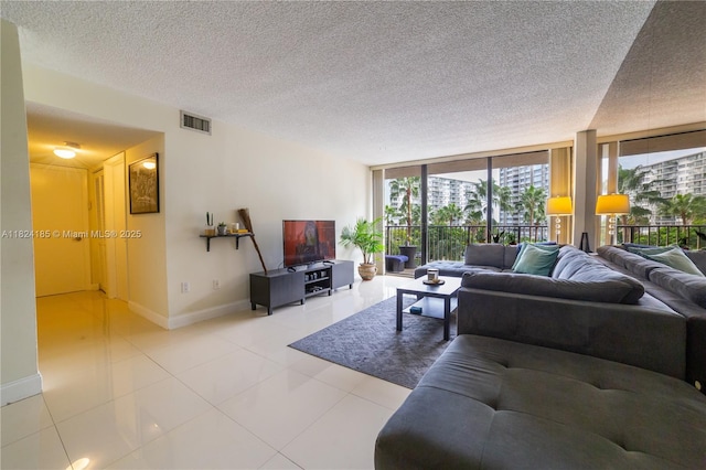 1450 Brickell Bay Dr Unit 311, Miami, FL 33131 - living area with floor to ceiling windows, a textured ceiling, and tile patterned flooring
