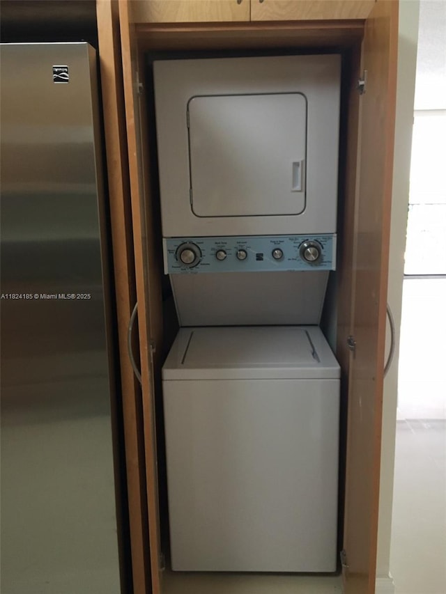 1450 Brickell Bay Dr Unit 311, Miami, FL 33131 - washroom featuring stacked washing machine and dryer