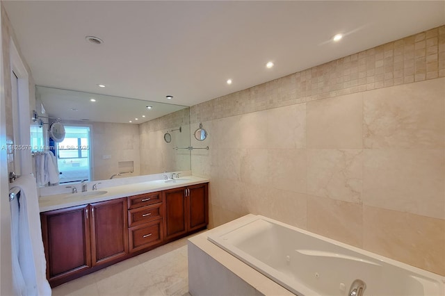 3 Grove Isle Dr Unit C1405, Miami, FL 33133 - full bathroom featuring a jetted tub, double vanity, tile walls, and recessed lighting