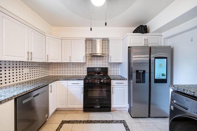 12995 NE 5th Ave, North Miami, FL 33161 - kitchen featuring appliances with stainless steel finishes, wall chimney range hood, washer / clothes dryer, light tile patterned flooring, and inlaid floor details