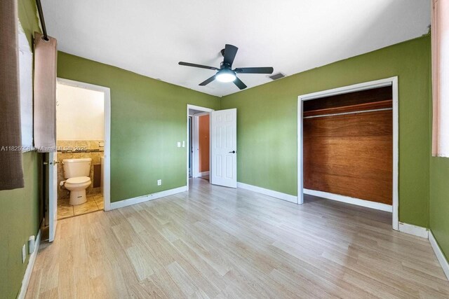 12995 NE 5th Ave, North Miami, FL 33161 - unfurnished bedroom featuring light wood-style flooring, a closet, ceiling fan, and ensuite bathroom