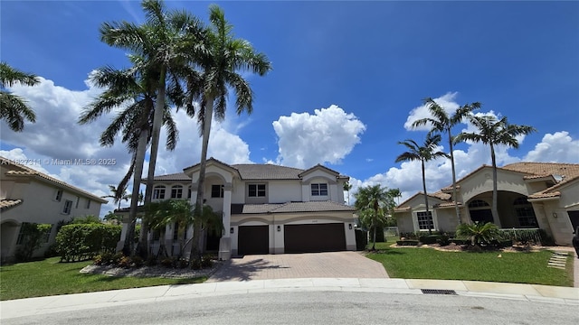 1425 Crossbill Ct, Weston, FL 33327 - mediterranean / spanish-style house with an attached garage, decorative driveway, a front lawn, stucco siding, and a tile roof