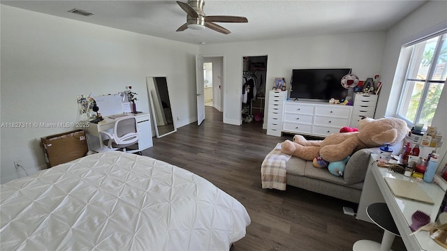 1425 Crossbill Ct, Weston, FL 33327 - bedroom featuring dark wood finished floors, a ceiling fan, and washing machine and clothes dryer
