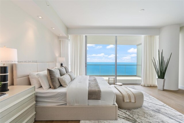 10203 Collins Ave Unit 1603, Bal Harbour, FL 33154 - bedroom with access to exterior, wood finished floors, a water view, and recessed lighting