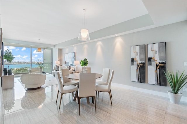 10203 Collins Ave Unit 1603, Bal Harbour, FL 33154 - dining space featuring light tile patterned floors and a water view