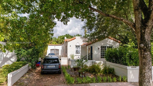 1210 Genoa St, Coral Gables, FL 33134 - mediterranean / spanish home featuring a tiled roof and stucco siding