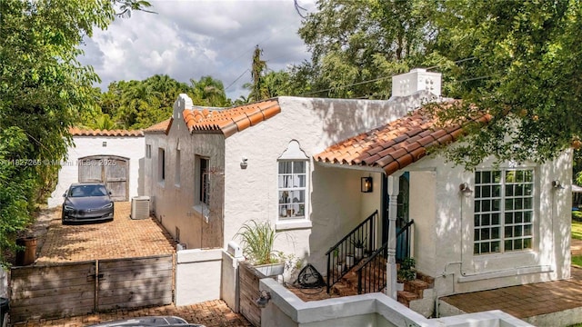 1210 Genoa St, Coral Gables, FL 33134 - view of front facade with a tiled roof and stucco siding