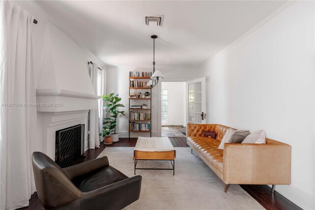 1210 Genoa St, Coral Gables, FL 33134 - living area featuring wood finished floors, a fireplace, and ornamental molding