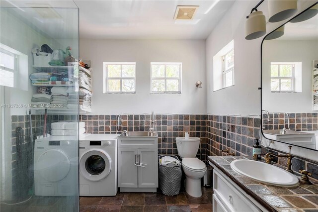 1210 Genoa St, Coral Gables, FL 33134 - full bathroom featuring washer and dryer, walk in shower, vanity, tile walls, and a wainscoted wall