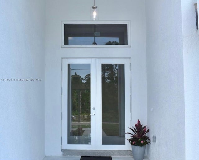 521 S Frank Jewett, Lehigh Acres, FL 33974 - view of exterior entry featuring french doors and stucco siding