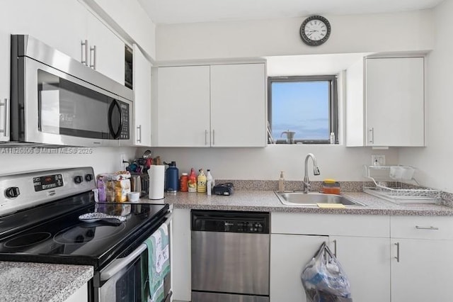 3300 NE 192nd St Unit 1707, Aventura, FL 33180 - kitchen with appliances with stainless steel finishes, white cabinetry, and light countertops