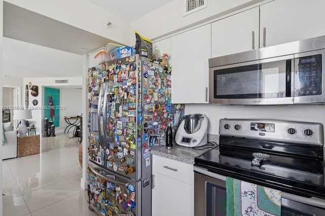 3300 NE 192nd St Unit 1707, Aventura, FL 33180 - kitchen featuring appliances with stainless steel finishes, white cabinets, and light countertops