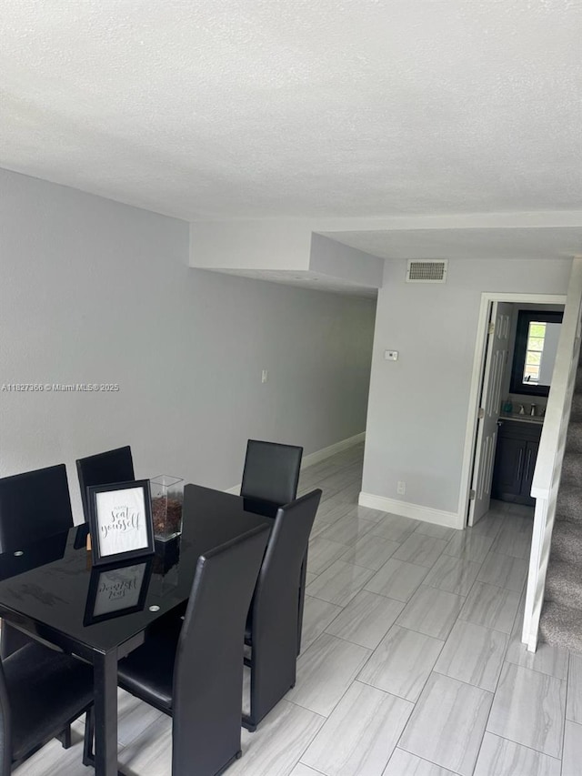 9500 SW 3rd St Unit 239, Boca Raton, FL 33428 - dining area featuring a textured ceiling and stairway