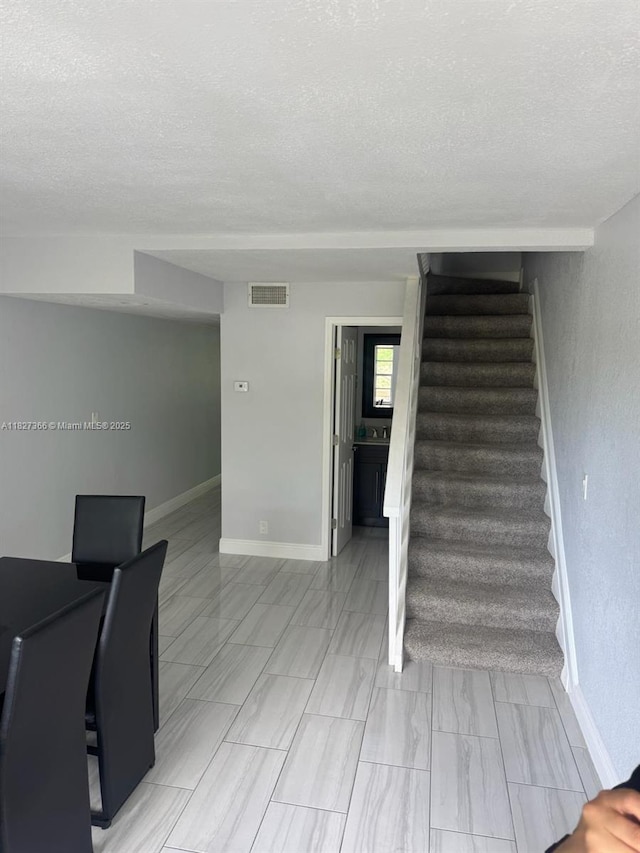 9500 SW 3rd St Unit 239, Boca Raton, FL 33428 - stairs with a textured ceiling and baseboards