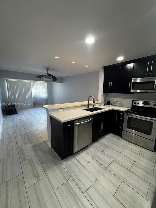 9500 SW 3rd St Unit 239, Boca Raton, FL 33428 - kitchen featuring stainless steel appliances, dark cabinets, light countertops, a ceiling fan, and recessed lighting