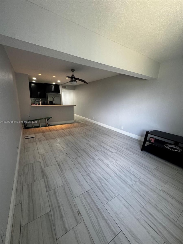 9500 SW 3rd St Unit 239, Boca Raton, FL 33428 - unfurnished living room featuring ceiling fan and baseboards
