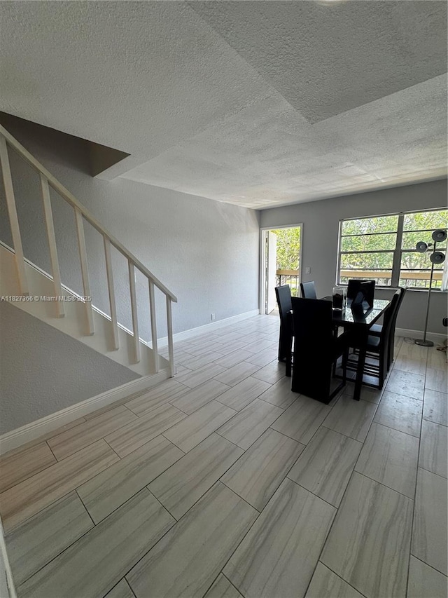 9500 SW 3rd St Unit 239, Boca Raton, FL 33428 - dining room with stairway and a textured ceiling