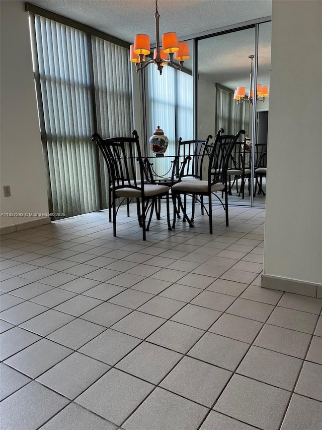 11790 SW 18th St Unit 321-3, Miami, FL 33175 - dining room with a chandelier, a wall of windows, and a textured ceiling