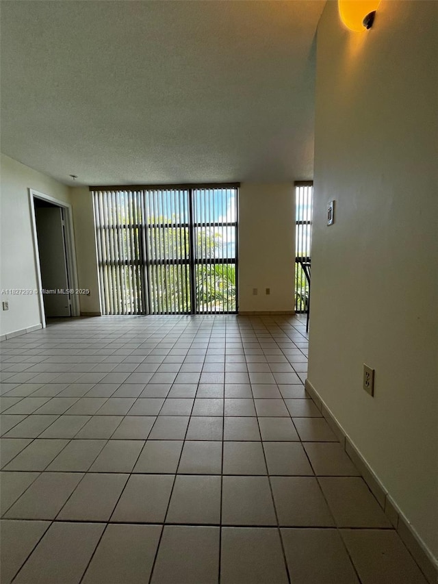 11790 SW 18th St Unit 321-3, Miami, FL 33175 - unfurnished room featuring healthy amount of natural light, light tile patterned flooring, and a textured ceiling