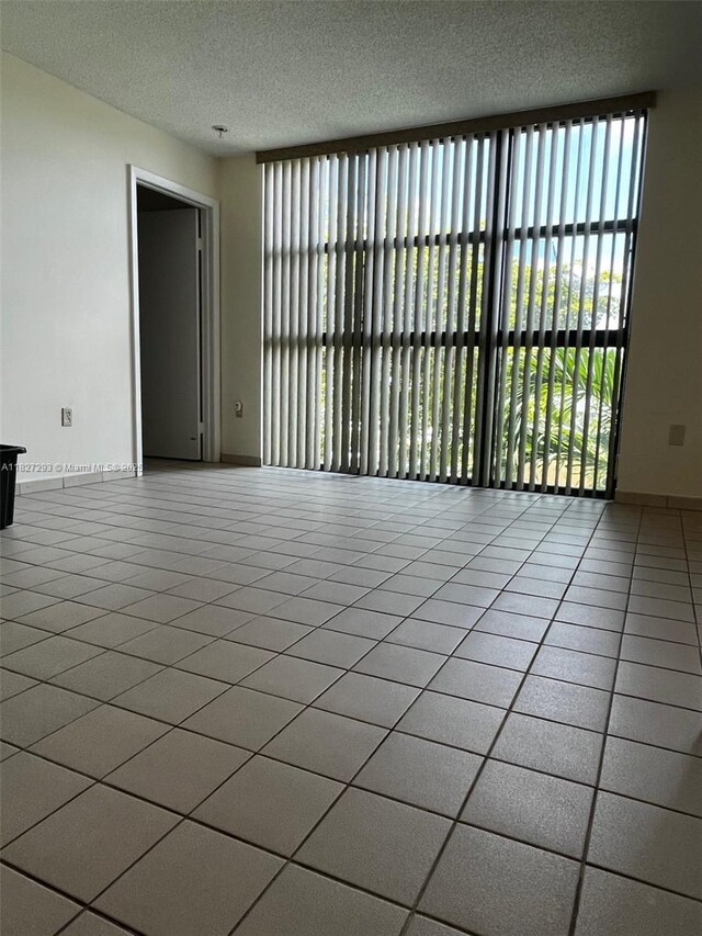 11790 SW 18th St Unit 321-3, Miami, FL 33175 - unfurnished room featuring a textured ceiling and tile patterned flooring