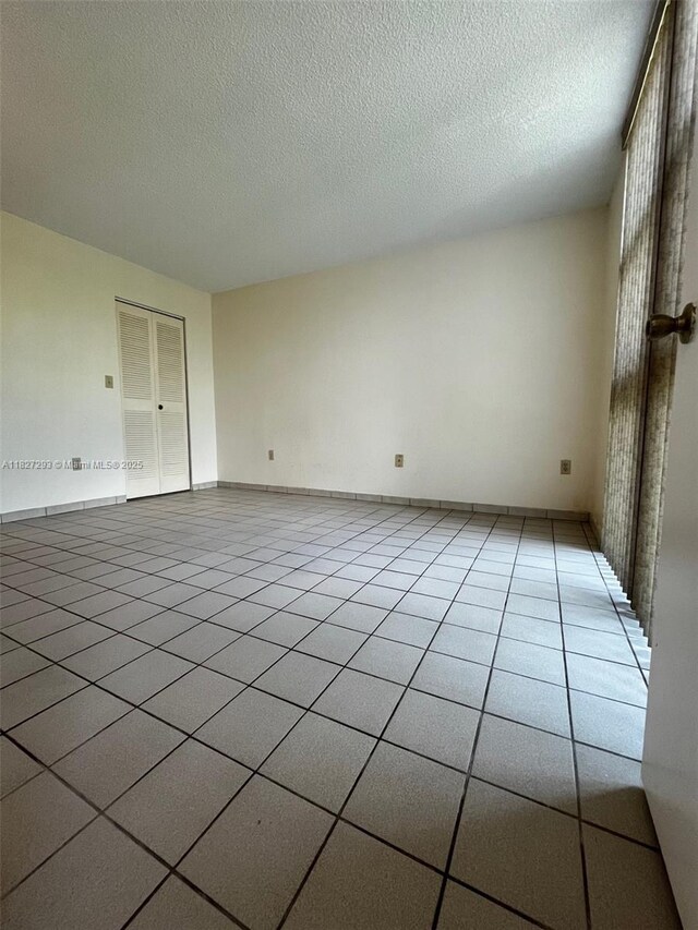 11790 SW 18th St Unit 321-3, Miami, FL 33175 - unfurnished room with a textured ceiling and light tile patterned flooring
