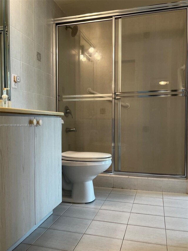 11790 SW 18th St Unit 321-3, Miami, FL 33175 - full bathroom featuring tile walls, tile patterned floors, and a shower stall