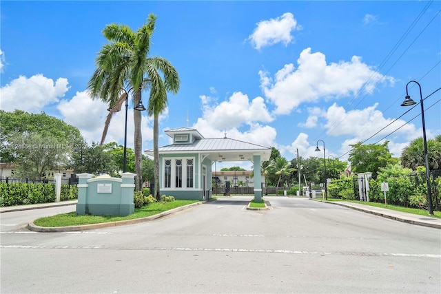 1817 NW 54th Ter Unit Bb4, Lauderhill, FL 33313 - view of asphalt road featuring street lighting, curbs, a gate, and a gated entry