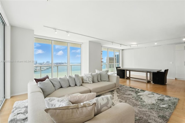 50 Biscayne Blvd Unit 3002, Miami, FL 33132 - living room featuring rail lighting, a water view, and light wood-type flooring