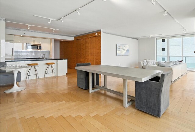 50 Biscayne Blvd Unit 3002, Miami, FL 33132 - kitchen with track lighting, stainless steel microwave, tasteful backsplash, a kitchen breakfast bar, and open floor plan