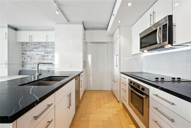 50 Biscayne Blvd Unit 3002, Miami, FL 33132 - kitchen with stainless steel appliances, backsplash, white cabinets, dark stone counters, and recessed lighting