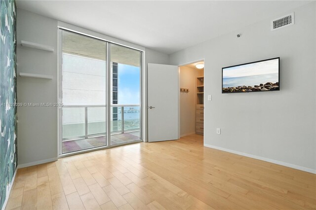 50 Biscayne Blvd Unit 3002, Miami, FL 33132 - spare room with light wood-style flooring and floor to ceiling windows