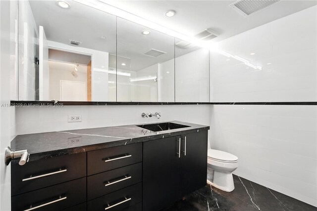 50 Biscayne Blvd Unit 3002, Miami, FL 33132 - bathroom featuring vanity, marble look tiles, and recessed lighting